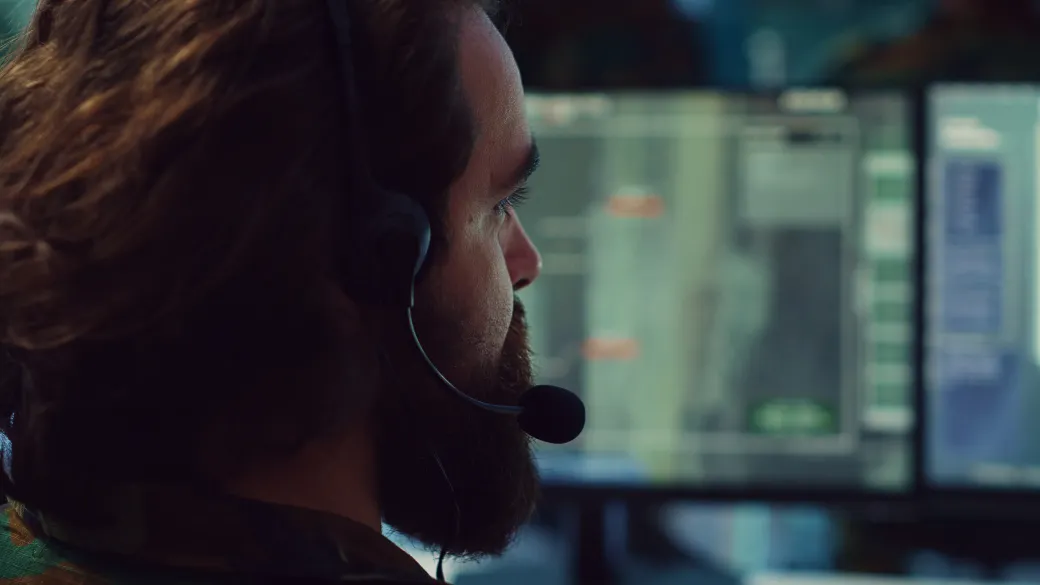 Customer support representative, wearing a headset and happily helping others.